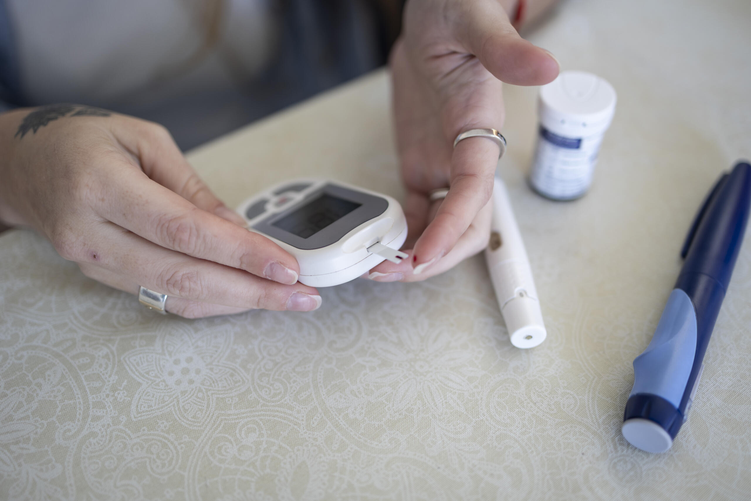 Woman performing a glucose test before administering insulin