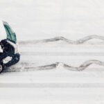 a car swerves on a snow-covered road