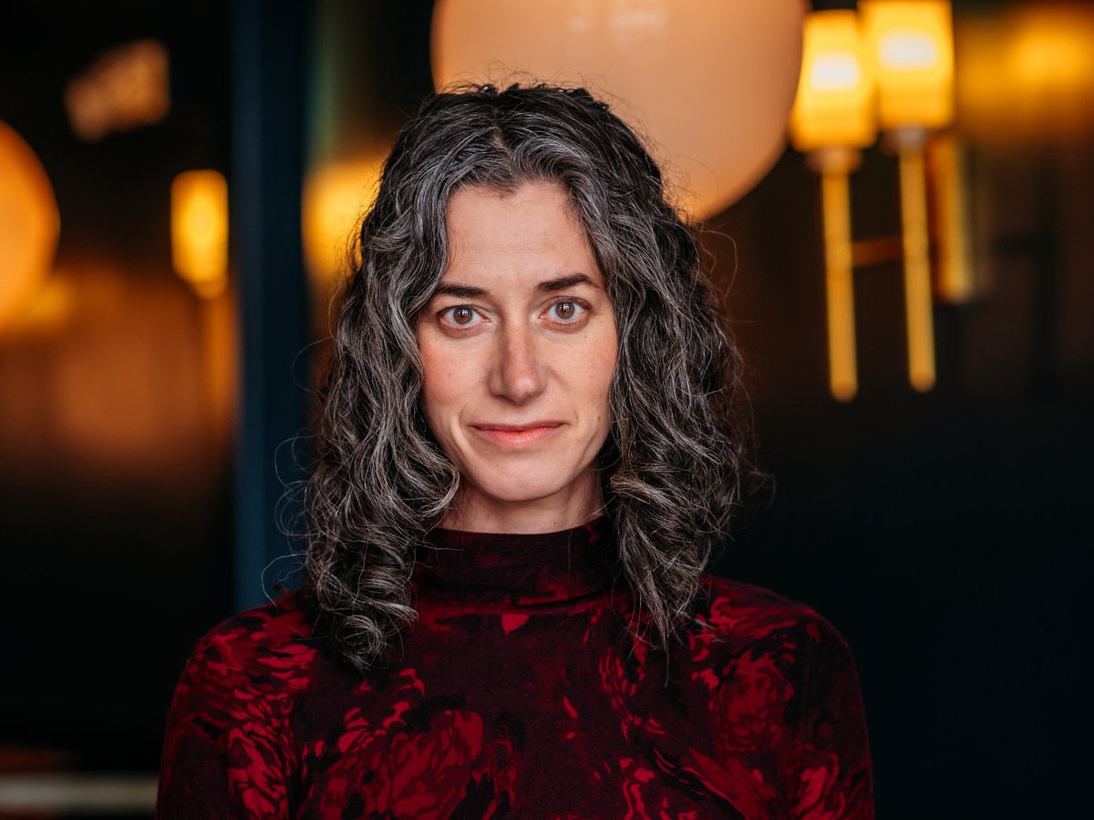 Veteran journalist Julie Wernau wears a red sweater.