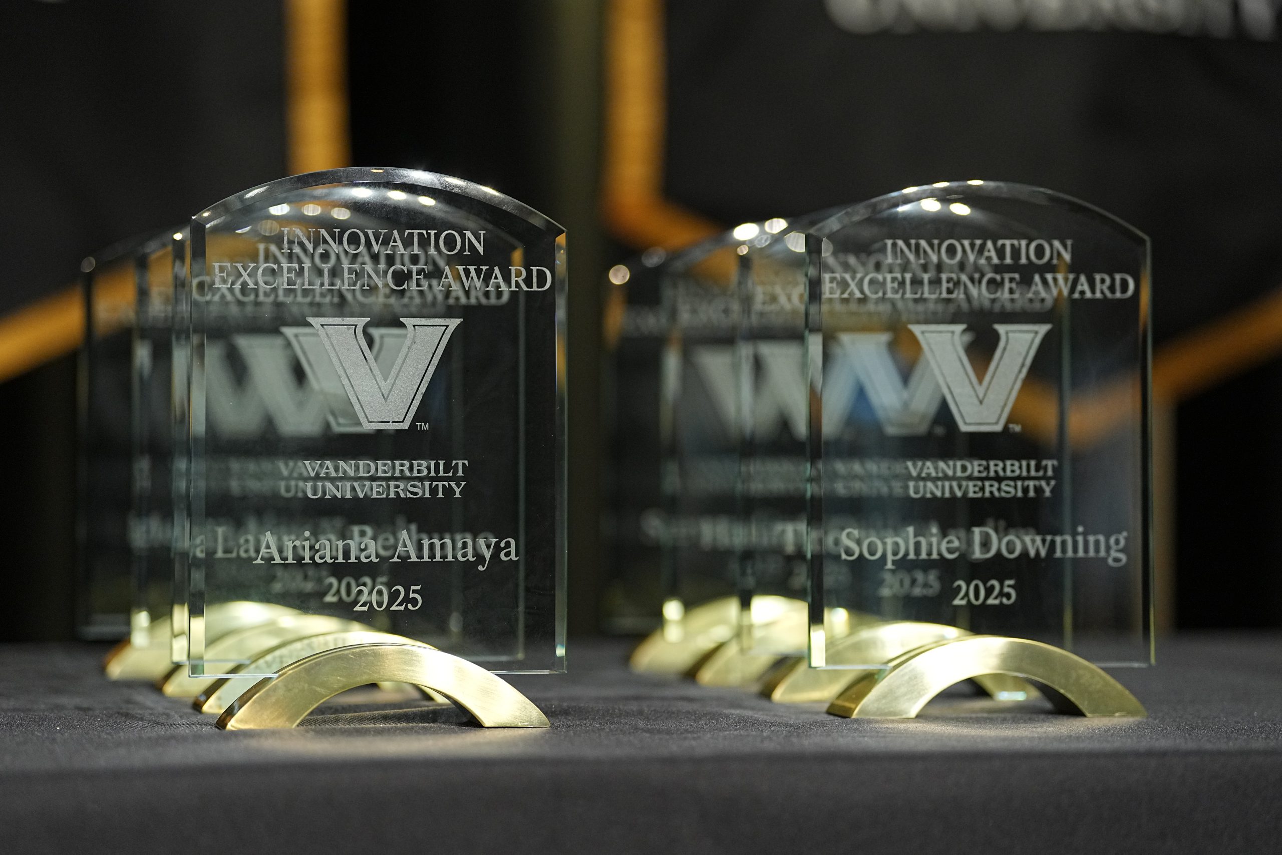 Crystal awards lined up on a black table