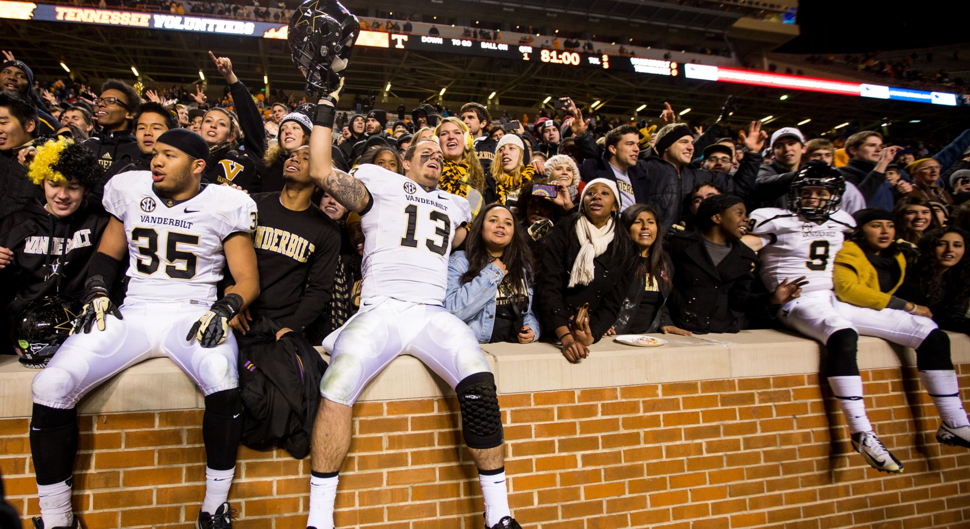 Commodore players celebrate with fans after defeating Tennessee.