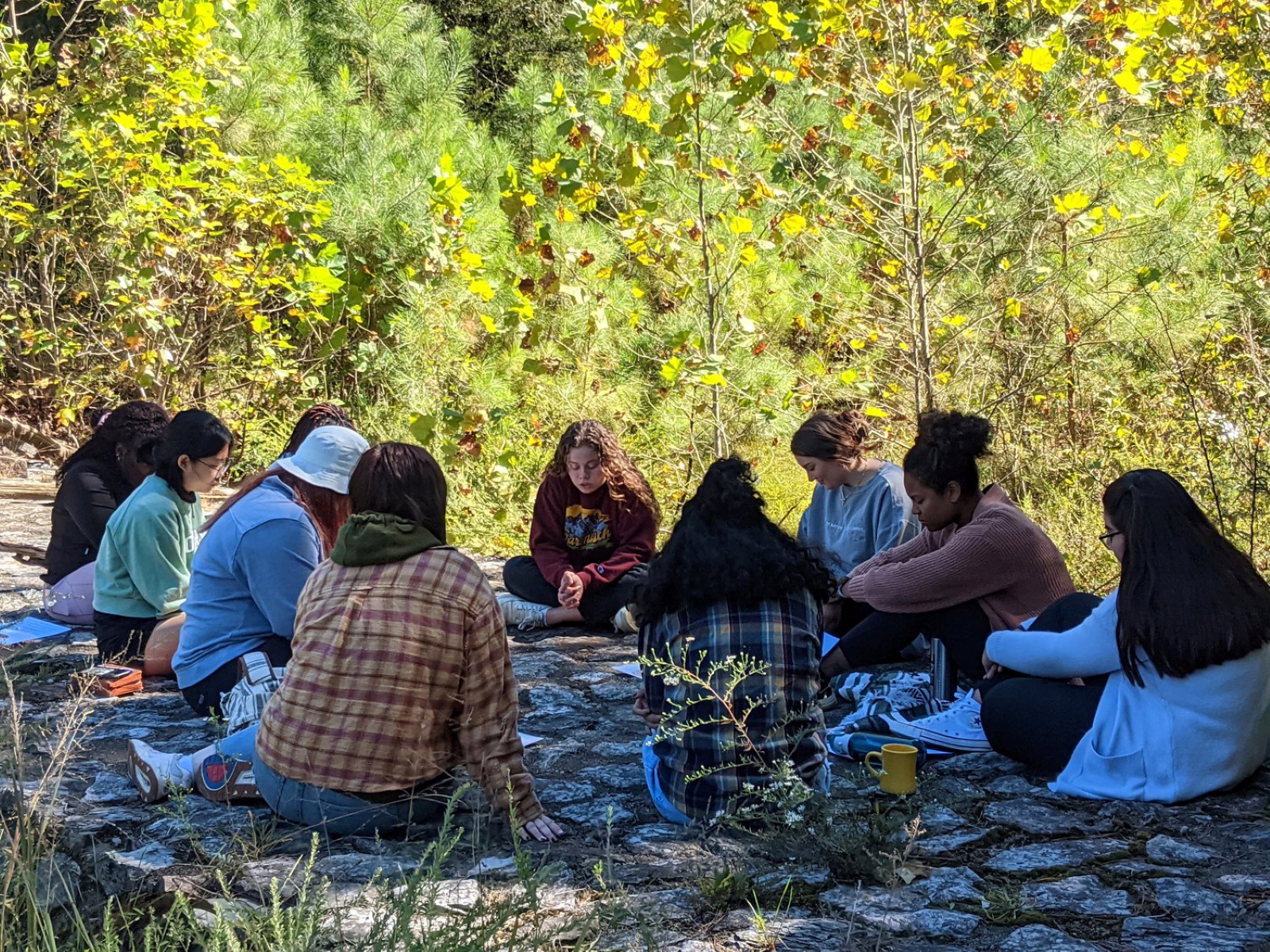 students praying in a circle
