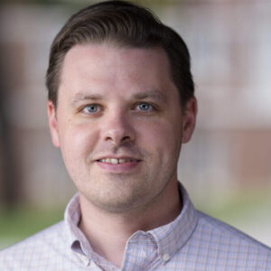 Chance Meers smiling in a light colored t-shirt