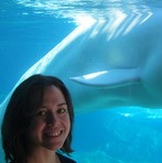 Woman standing in front of whale