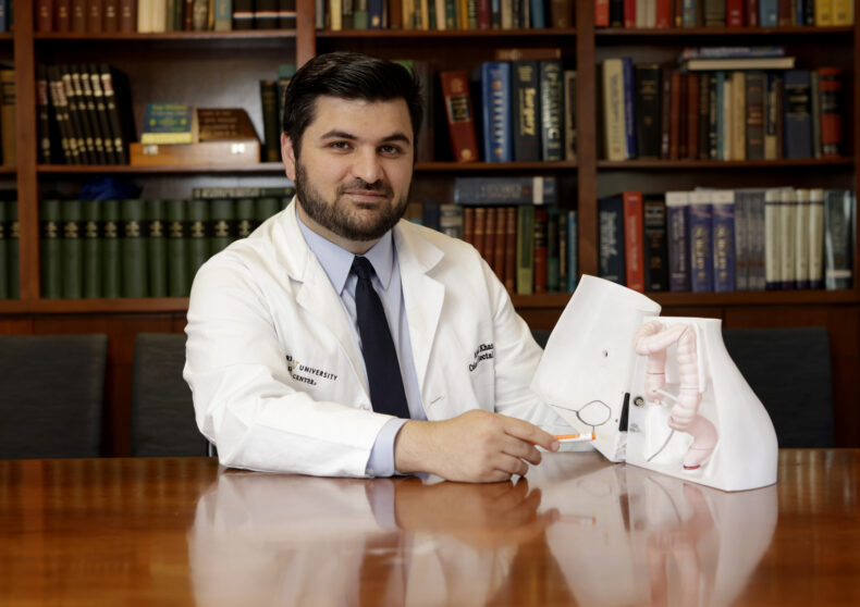Aimal Khan, MD, with one of the 3D models he created to use during preoperative consultations. (photo by Donn Jones)