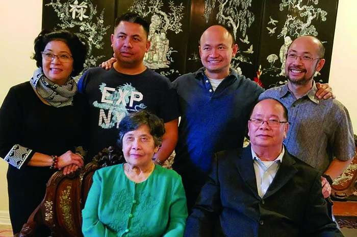 Duc Pham and his family, all Vietnamese, in a family photo. His mother and father sit in the front; Duc, two brothers and one sister stand behind them.
