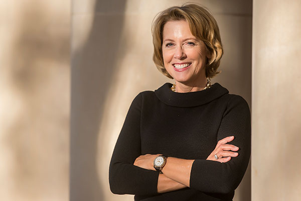 Mariann Piano stands with her arms crossed